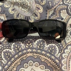 Black Chanel sunglasses with white double c logo and flower.